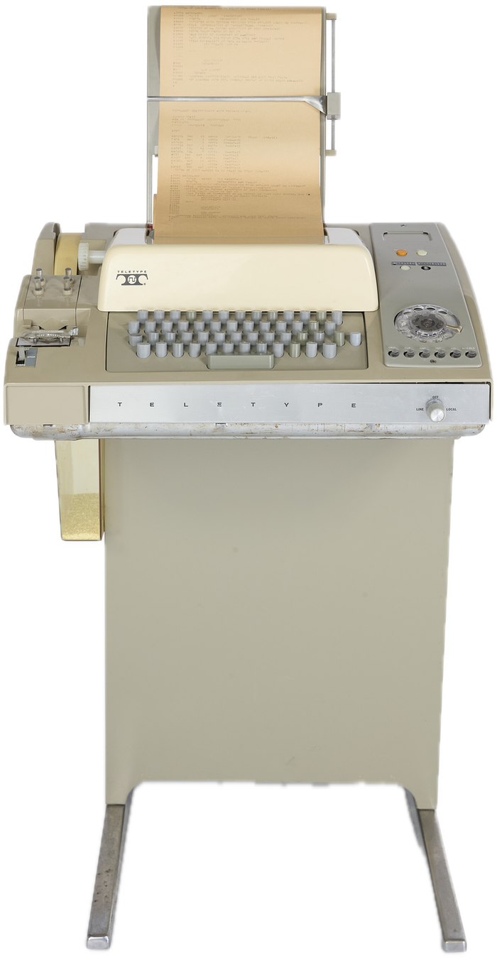A Teletype Model 33 on its stand, printout in the roll.